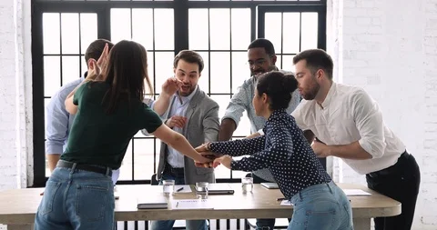 Happy multiethnic business group stack hands together over meeting table Stock Footage 123102859