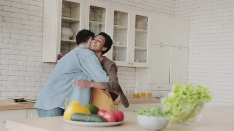 Happy multiethnic couple dancing in the kitchen. Young african american woman Video stock 236490421