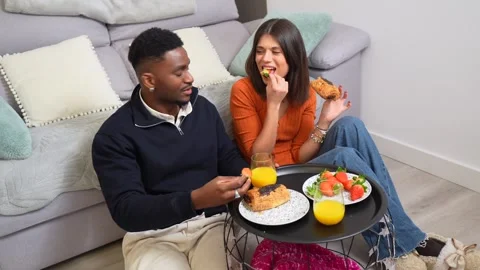Happy multiethnic couple enjoying breakfast at home Stock Footage 304792001