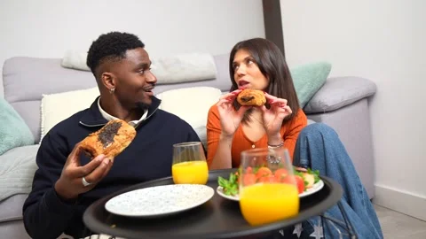 Happy multiethnic couple enjoying breakfast at home Stock Footage 304792009