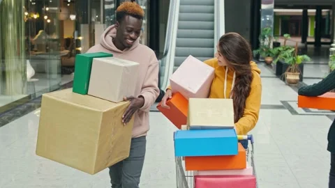 Happy Multiethnic Couple Walking With Shoping Bags in the Mall. Couple are Stock Footage 142101706
