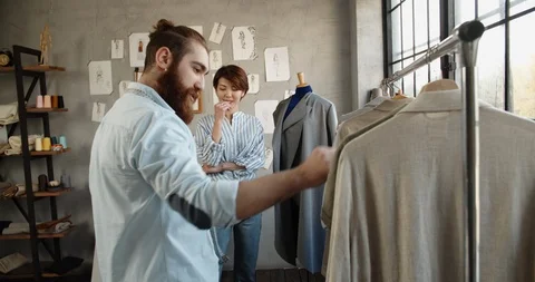 A happy multiethnic couple is working as tailors together, designing new clothes Video stock 127147384