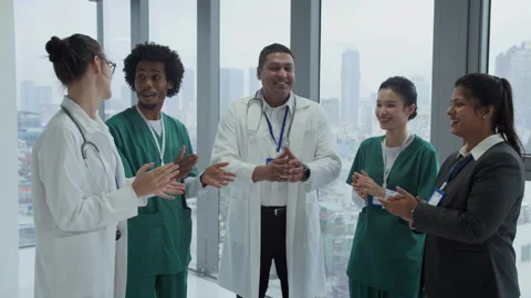 Happy Multiethnic Doctors Clapping Hands in Hospital Hall 動画素材 287330739