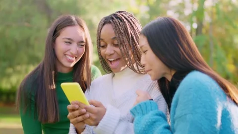 Happy multiethnic friends having fun using the mobile outdoors Vídeos de archivo 234858302
