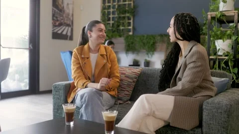 Happy multiethnic friends having fun drinking coffee at urban cafeteria Video stock 244602515