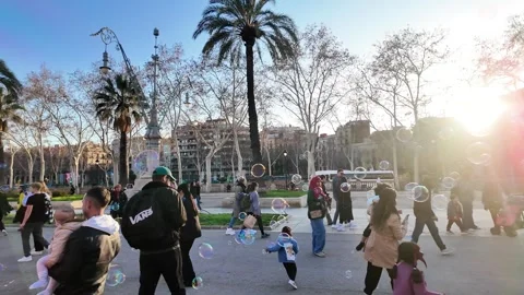 Happy multinational children playing with soap bubbles on a busy street, 4K Stock Footage 271131625