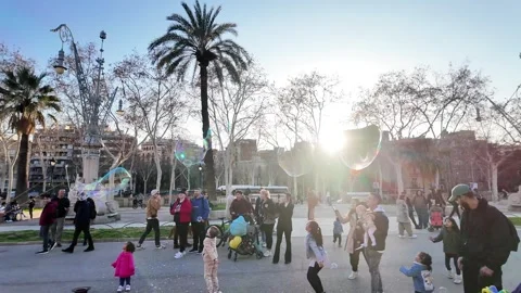 Happy multinational children playing with soap bubbles on a busy street, 4K Stock Footage 271131628