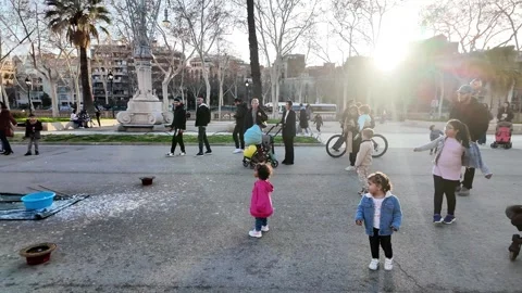 Happy multinational children playing with soap bubbles on a busy street, 4K Stock Footage 271131653