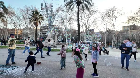 Happy multinational children playing with soap bubbles on a busy street, 4K Stock Footage 271131699