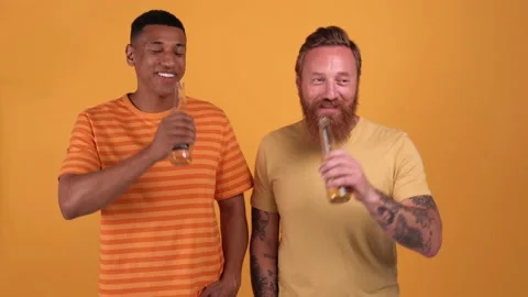 Happy multinational men clink and drink beer Stock Footage 205468807