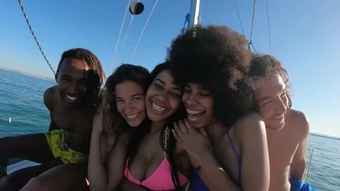 Happy multiracial friends streaming live video while doing sea tour Stock Footage 199237906
