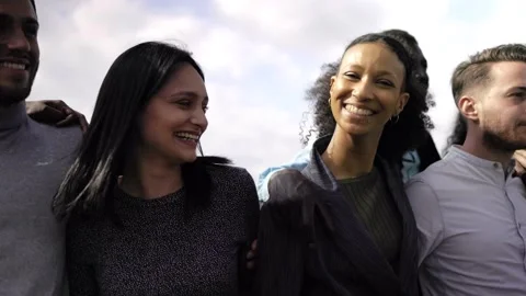 Happy multiracial group of friends having fun hugging outdoor Stock Footage 230246778