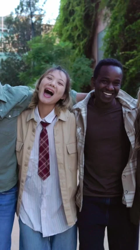 Happy multiracial group hugging each other walking towards de camera outdoors Stock Footage 288567145