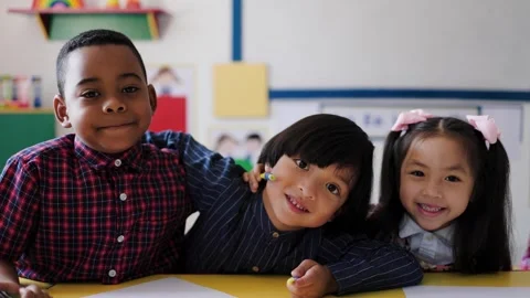 Happy multiracial kids having fun looking at camera at kindergarten school room Stock Footage 276480892