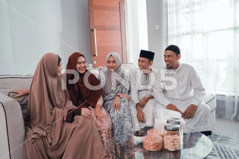 Happy muslim family sitting on the couch at home Stock Photos