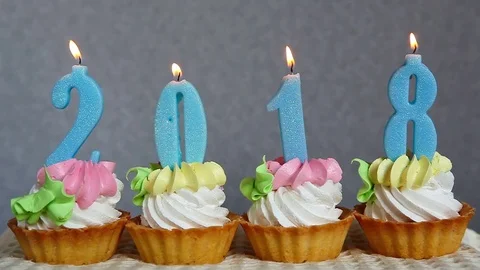 Happy new 2018 year , blue number candles on cupcakes Stock Footage 80791838