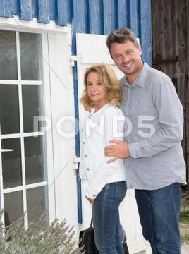 Happy new property owners in front of their house Stock Photos