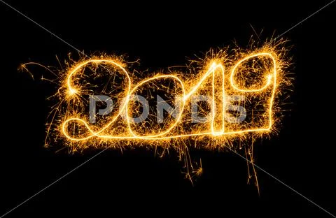 Happy New Year 2019 golden numbers written with Sparkle fireworks isolated on Stock Photos
