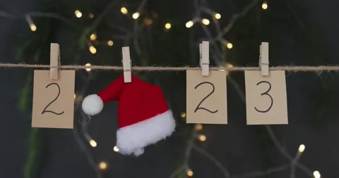 Happy new year 2023 background with numbers and red Santa hat. Winter holiday Stock Footage 224091526