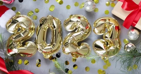 Happy new year 2023 background. Metallic balloons golden color on gray concrete Stock Footage 224095675