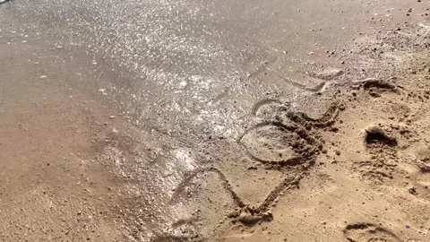 Happy New Year concept. Text 2023 and 2024 handwritten in sand surface. Blu.. Stock Footage 251801435