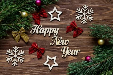Happy New Year. Ordered title with decoration on the wooden background with Stock Photos