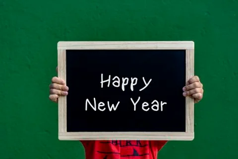 Happy new year  written blackboard by a children Stock Photos