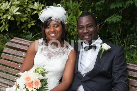 Happy newly wed african american couple on a bench Stock Photos