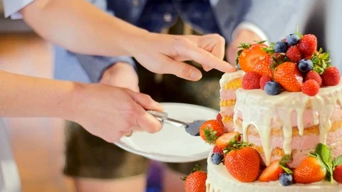 Happy newlyweds cutting the cake. Stock Footage 118541453