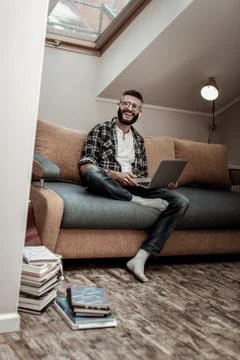 Happy nice man sitting on the sofa Stock Photos