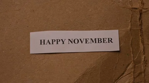 Happy November Message on Paper Note Placed by Hand Stock Footage 338268552