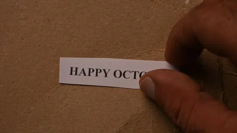 Happy October Message on Paper Note Placed by Hand on Torn Brown Card Background Stock Footage 338238687