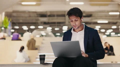 Happy Office Worker Gesturing in Distance Work Meeting while Sitting Inside in Stock-Footage 303147939