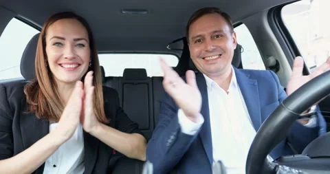 Happy office workers sit in car and rejoice with project Stock Footage 253170934