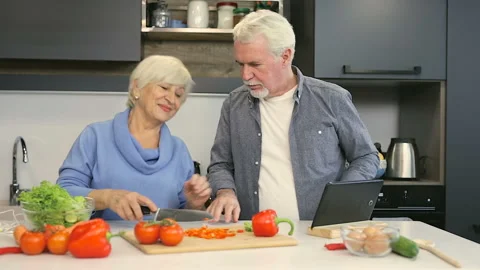 Happy old aged couple in good mood having fun at the kitchen. Stock Footage 102434669