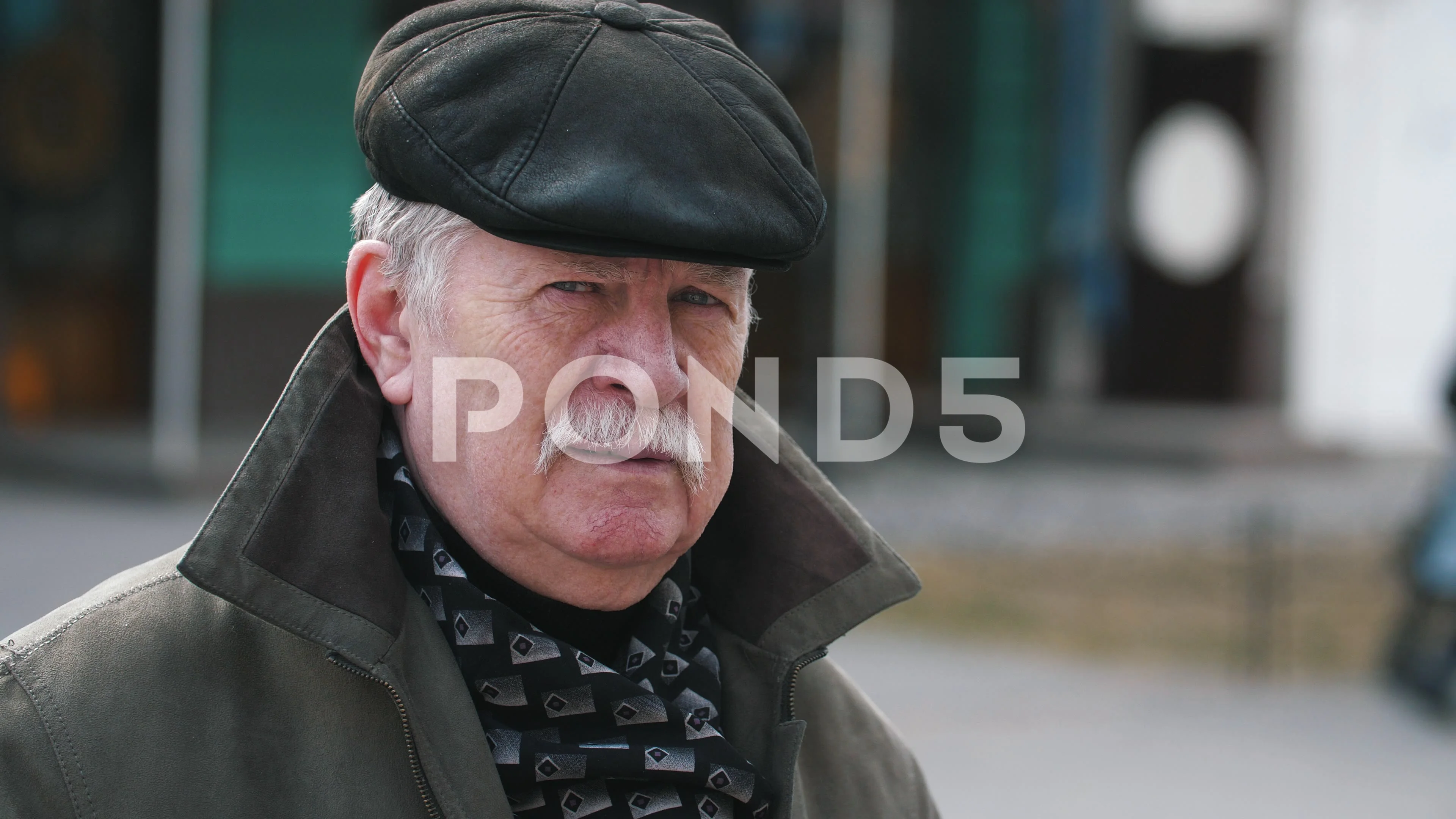 Happy old man with a mustache in a cap 
