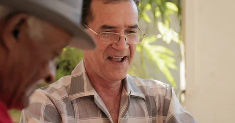 Happy Old Man Smiling And Playing Domino With Friends Stock Footage 76970939