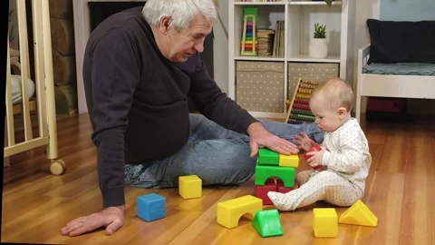 Happy old senior man playing with little baby. Grandfather with grandchild. Stock Footage 166966225