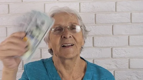 Happy old woman with money. | Stock Video | Pond5