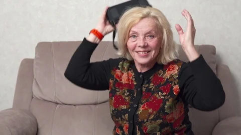 Happy old woman using virtual reality glasses Stock Footage 81799996