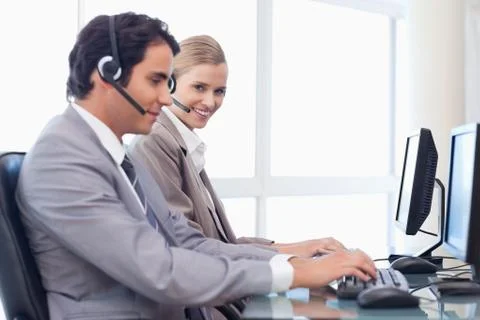 Happy operators using a computer Stockfoto's