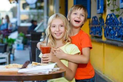 Happy or satisfied boy width girl eating pizza and drinking juice Stock Photos
