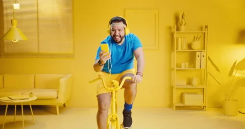 Happy overweight young man using mobile phone and chatting online or reading Stock Footage 165867506