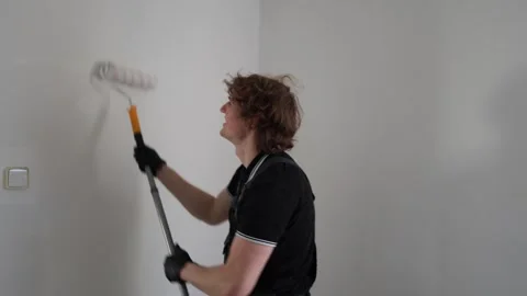 Happy painter refreshing apartment walls Stock Footage 335046632
