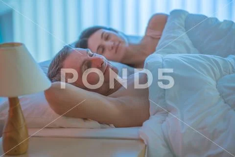 The happy pair sleeping on the bed Stock Photos