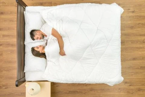 The happy pair sleeping on the bed. View from above Fotos Stock