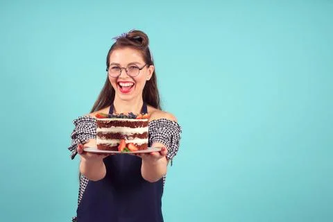 Happy pastry chef posing for the camera with a cake in his hands Stock Photos