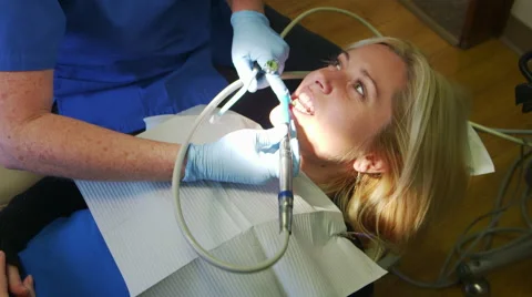 Happy Patient Getting Teeth Cleaned by Hygienist Stock-Footage 43336790