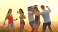 The happy people with a boom box dancing on a bright sun background. slow motion 4k or 4k+ Resolution