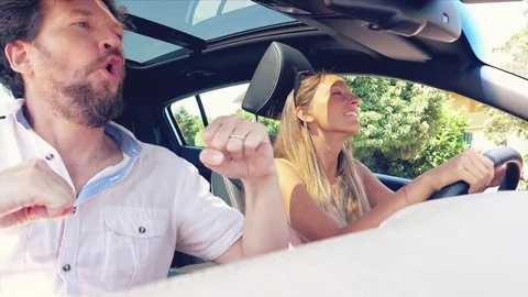 Happy people dancing in car dolly shot retro style slow motion Stock Footage 79799401